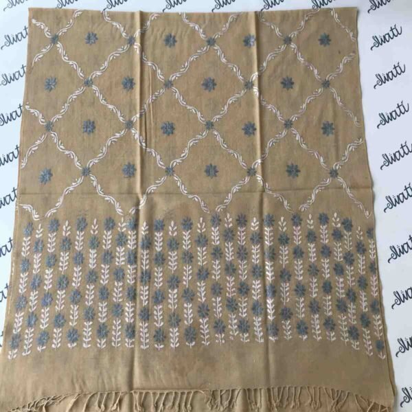 Women's wool shawl with intricate hand embroidery, featuring a warm biscuit color, perfect for winter styling