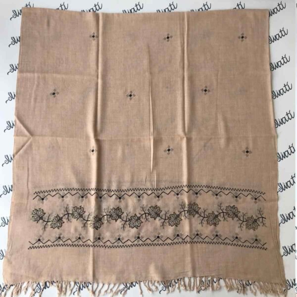 Light cream colored shawl with intricate black machine embroidery, offering warmth and elegance for winter wear