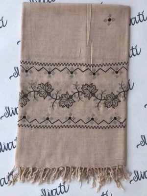 Light cream colored shawl with intricate black machine embroidery, offering warmth and elegance for winter wear